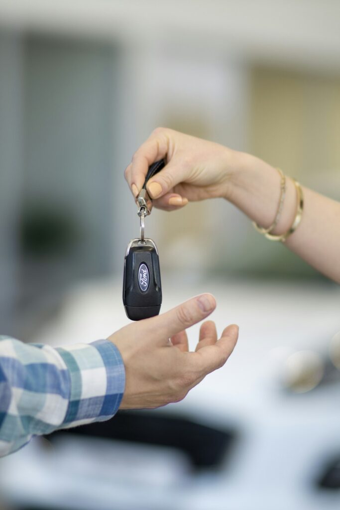 Keys being handed over to a customer collecting a hire vehicle